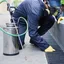 Ant control technician spraying along exterior edges and entry points in {city}, {state}